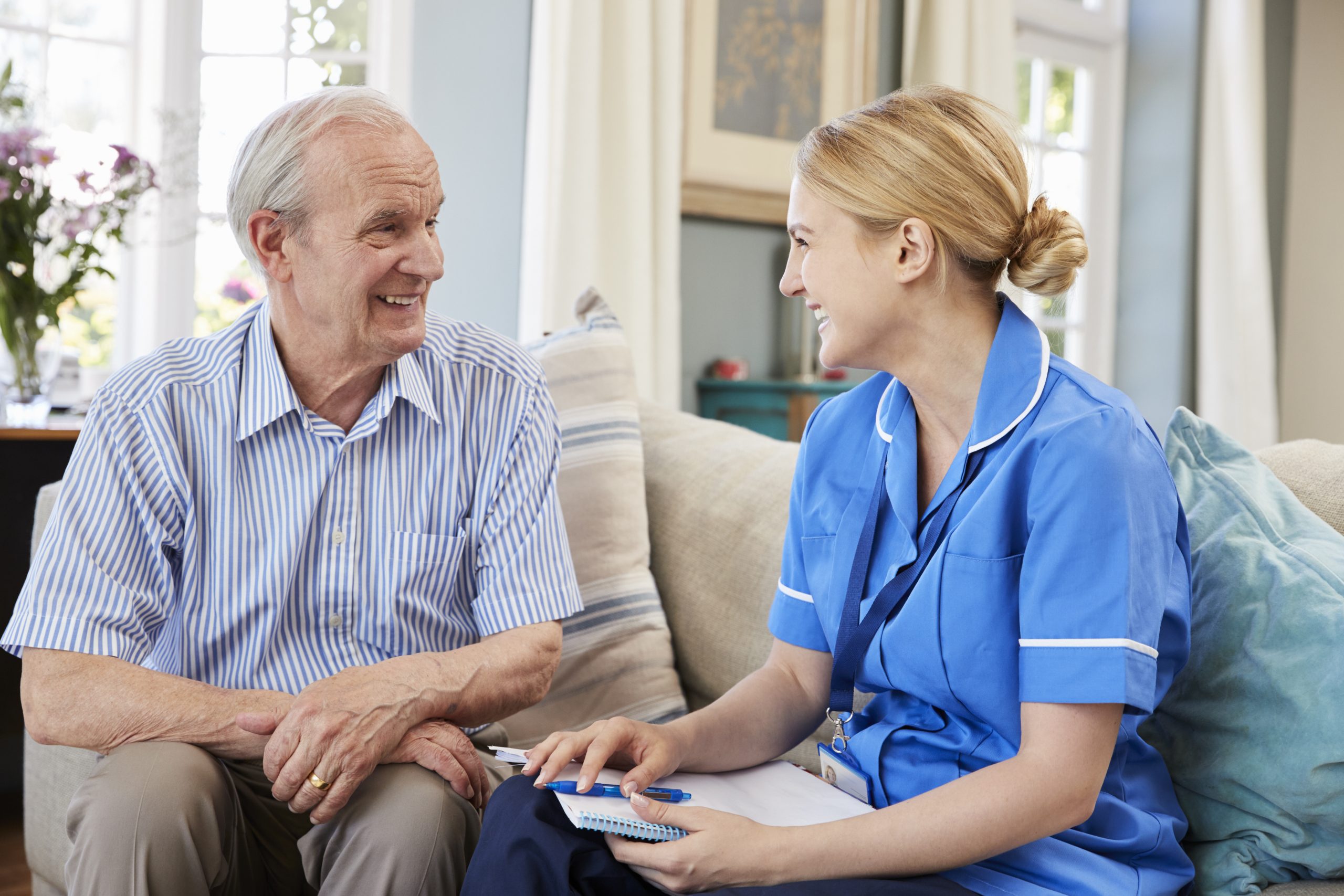 Female Community Nurse Visits Senior Man At Home;