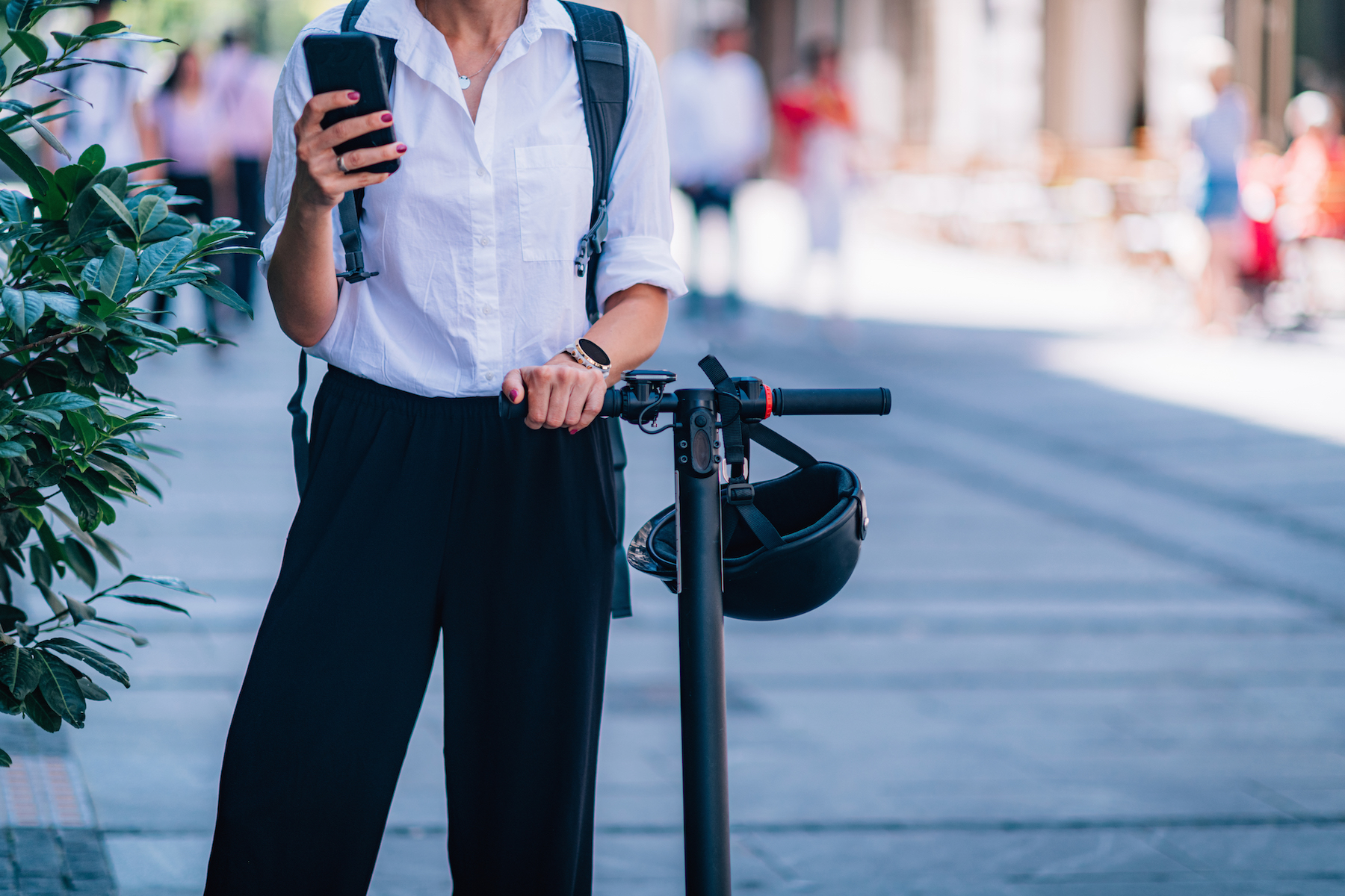 Businesswoman with Smart Phone and Electric Scooter in The City.;