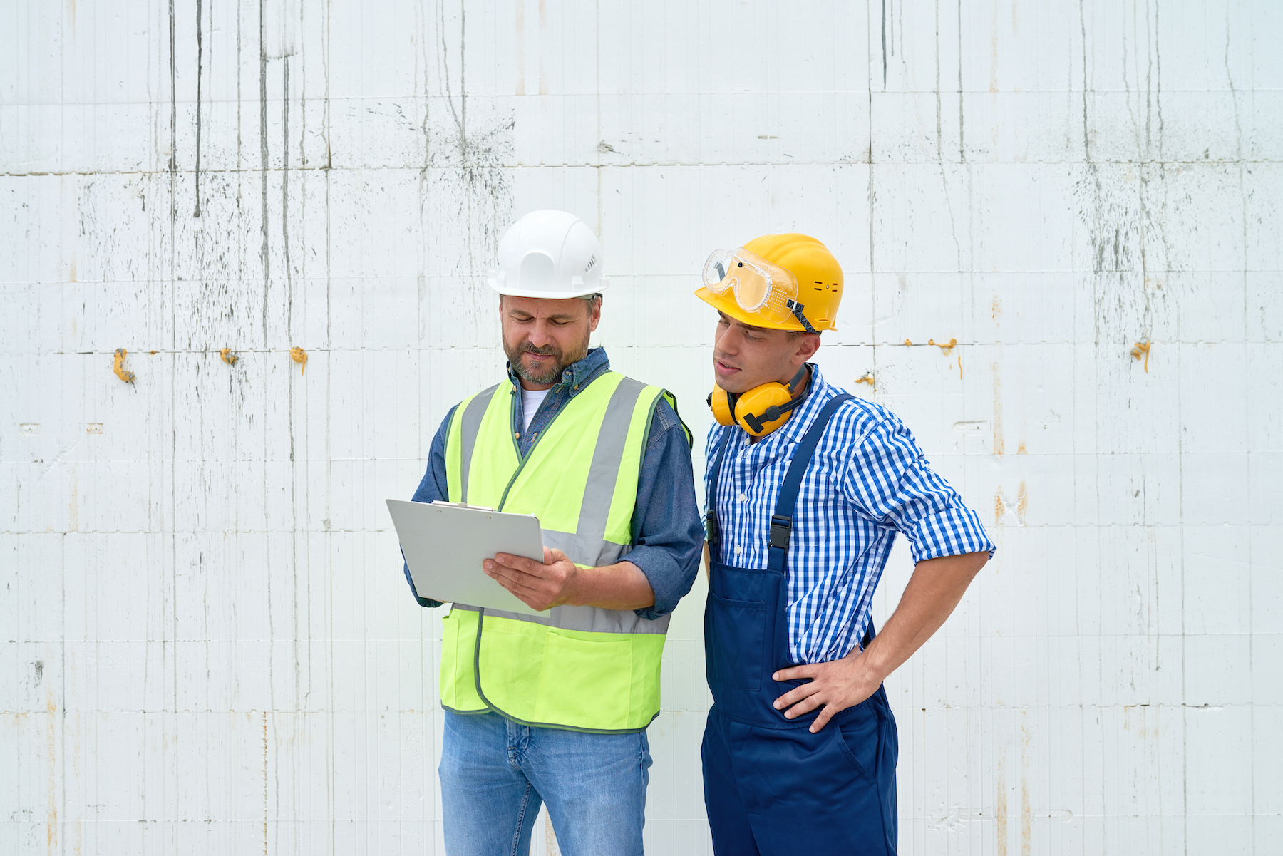 Construction Workers Discussing Building;